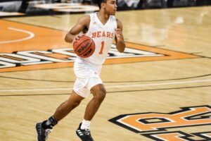 Mercer men's basketball player dribbles ball on the court