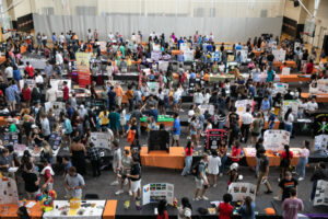 crowds mill around tables