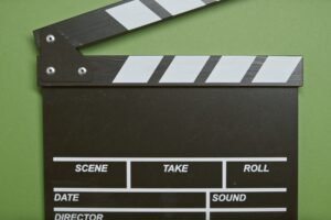 Clapper Board on Green Surface