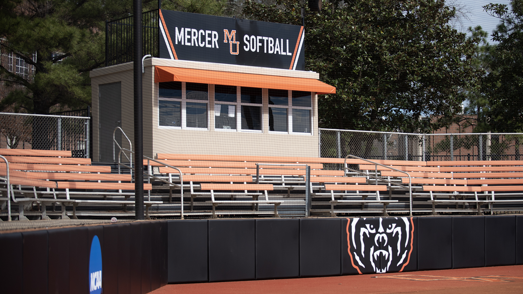 orange and black stands. sign says mercer softball