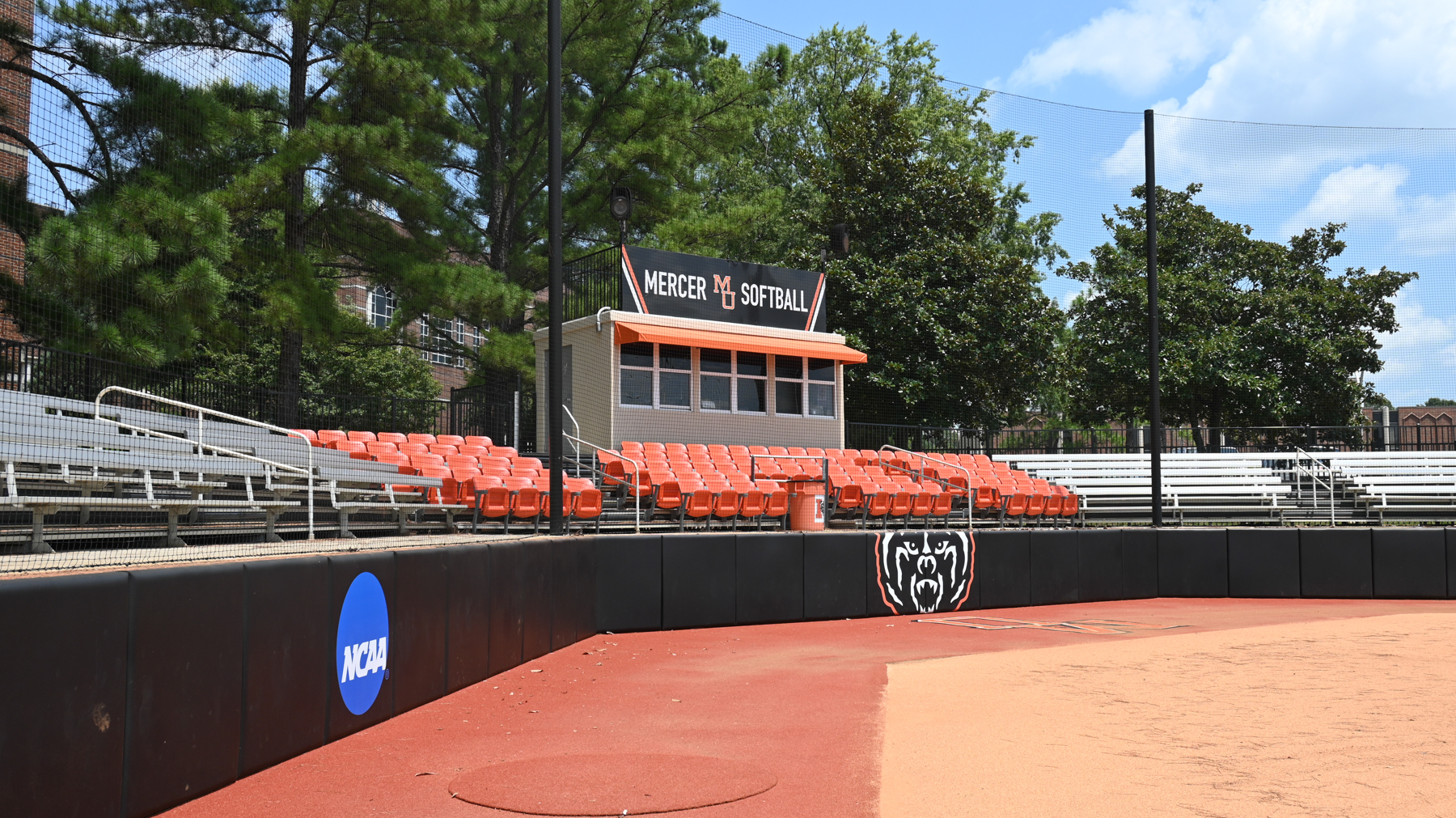 view of stands from diamond. sign says mercer softball
