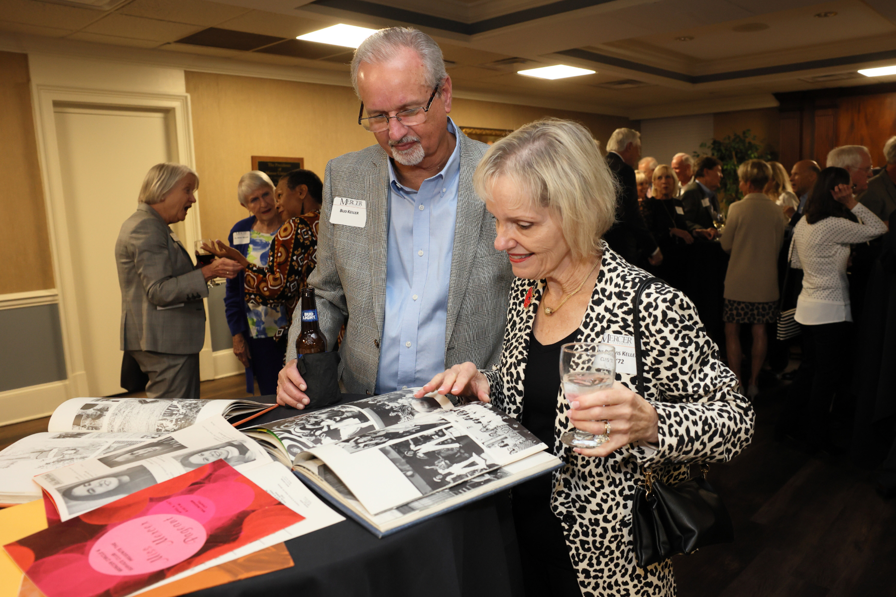 a man and a woman look at old yearbooks