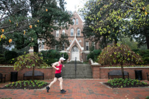 a man runs in front of the administration building