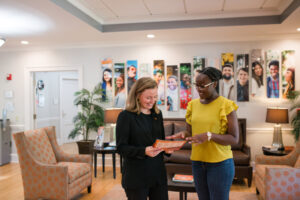 a counselor shows a prospective student a brochure
