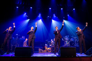 four male singers on stage