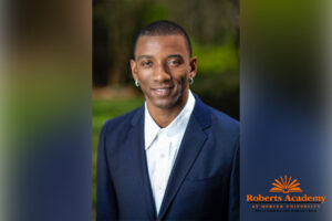 headshot of malcolm mitchell. roberts academy logo in lower right corner