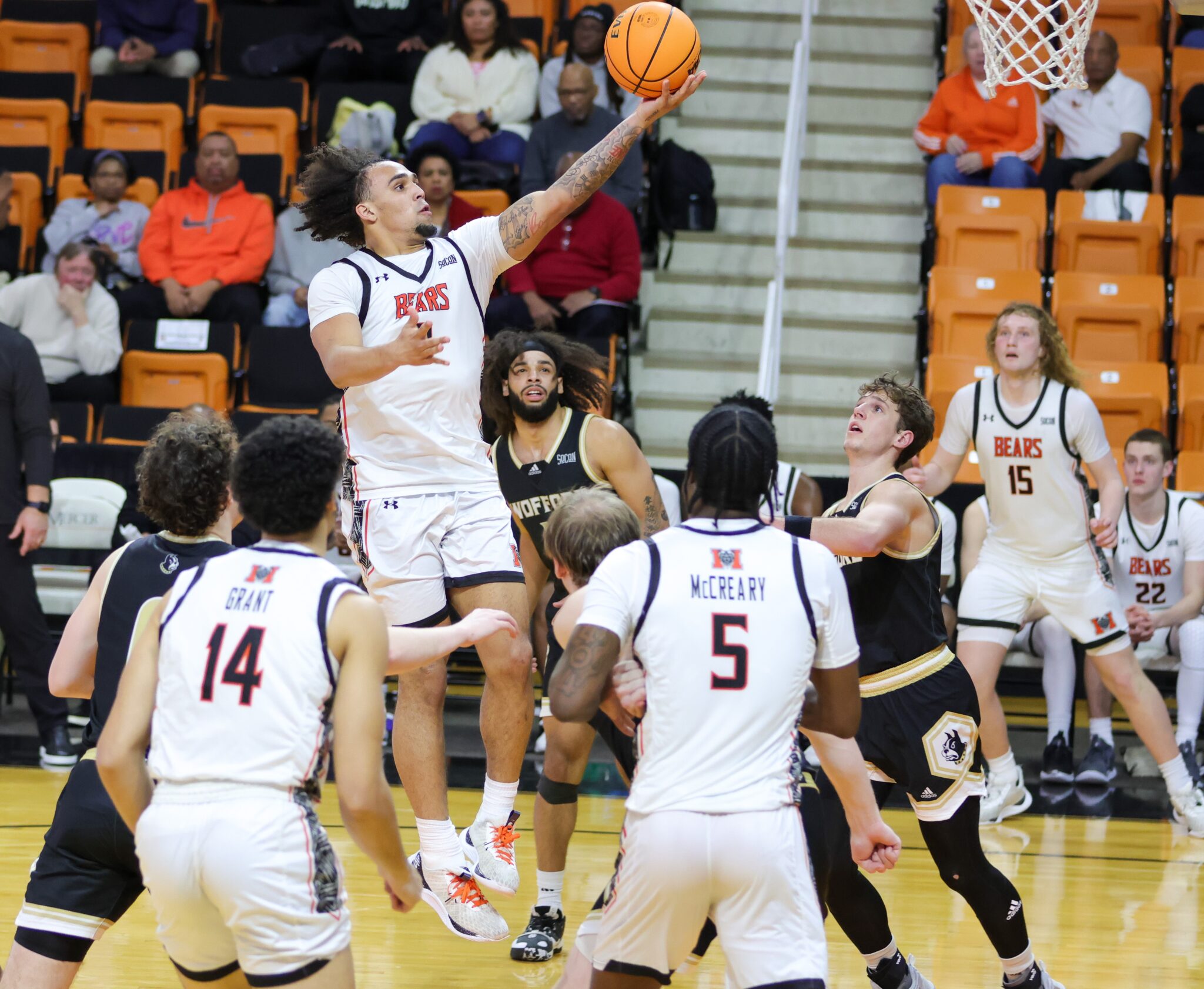 A Mercer men's basketball player shoots the ball during a game.