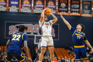 A Mercer basketball player shoots the ball during a game.