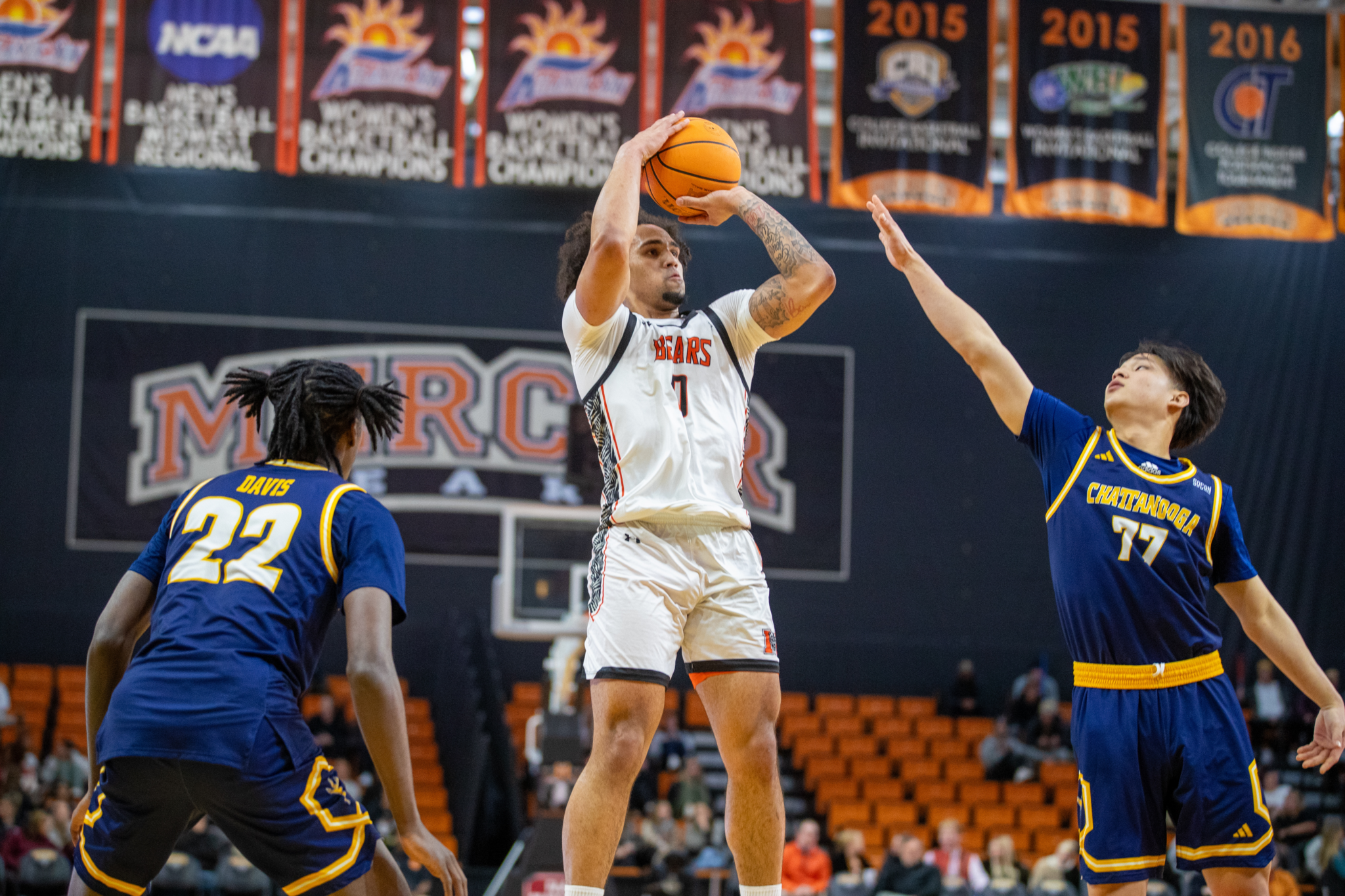 A Mercer basketball player shoots the ball during a game.