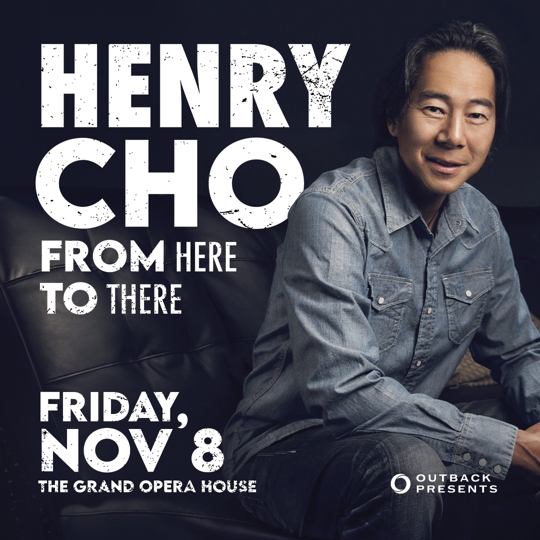 Promotional poster for comedian Henry Cho's show "From Here to There" on Friday, Nov. 8, at The Grand Opera House. The poster features Henry Cho sitting in a casual pose, wearing a denim jacket.