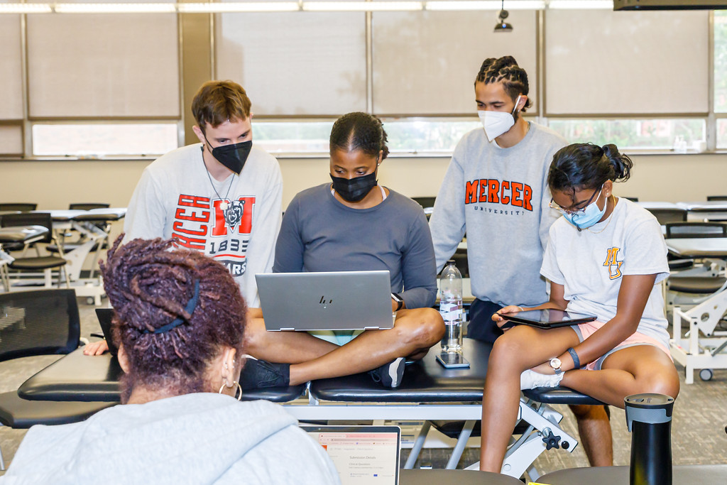 Four Mercer students in a classroom.