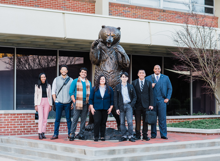 Mercer students gathered around the bear statue on the Atlanta campus.