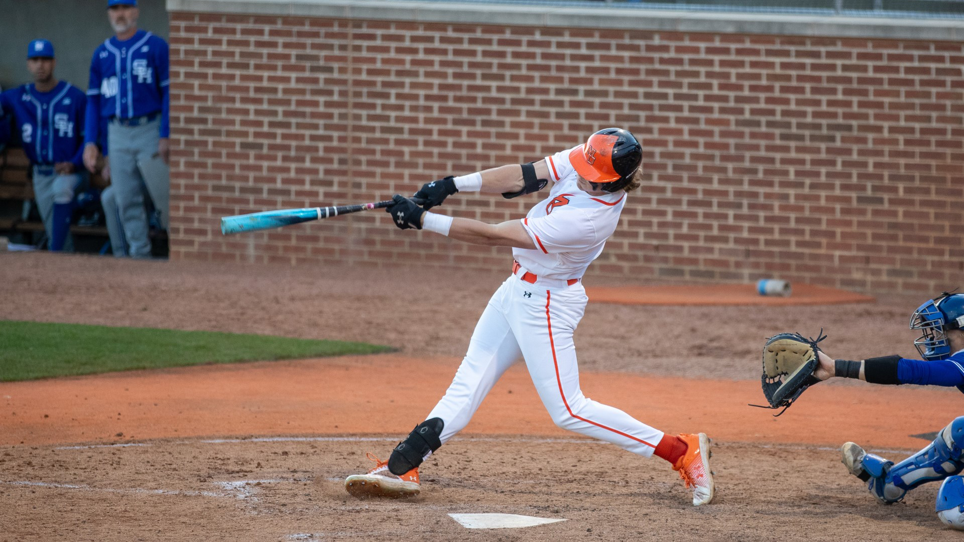 A Mercer baseball player swings a bat.