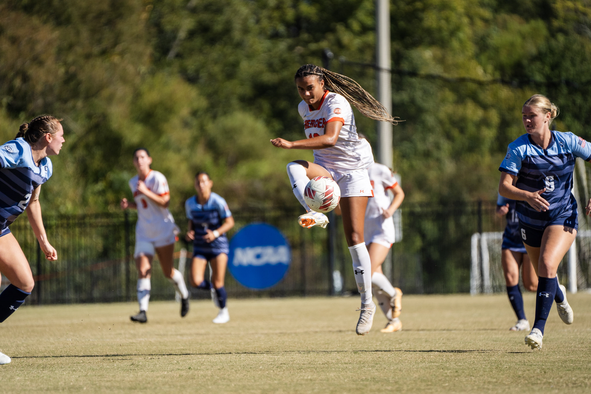 Mercer women's soccer playing kicks the ball during a match.