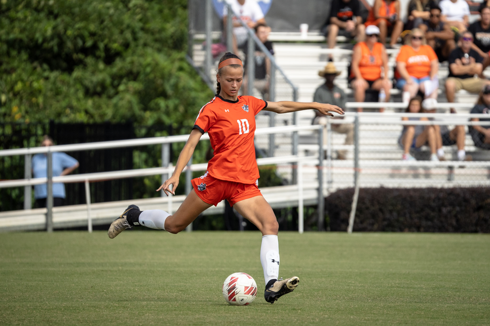 A Mercer soccer player kicks the ball during a match.