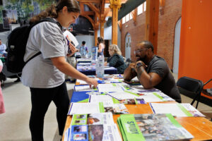 A Mercer student looks at a table covered in brochures and flyers about study abroad.