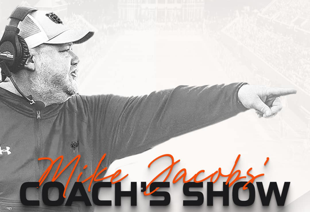 Black and white image of a football coach pointing, with the words Mike Jacobs' Coach's Show overlaying the photo.