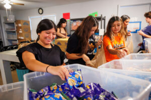 Mercer student put snack items in plastic grocery bags.
