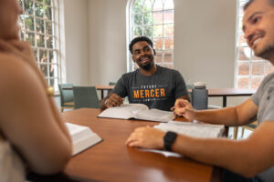 Law students converse around a table.