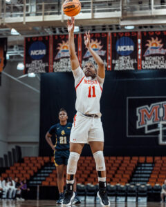 A Mercer women's basketball player shoots the ball during a game.