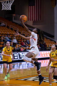 A Mercer women's basketball player shoots the ball during a game.