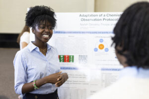 A Mercer student presents her poster at BEAR Day.
