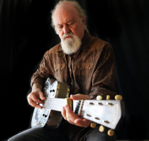 Tinsley Ellis playing a guitar.