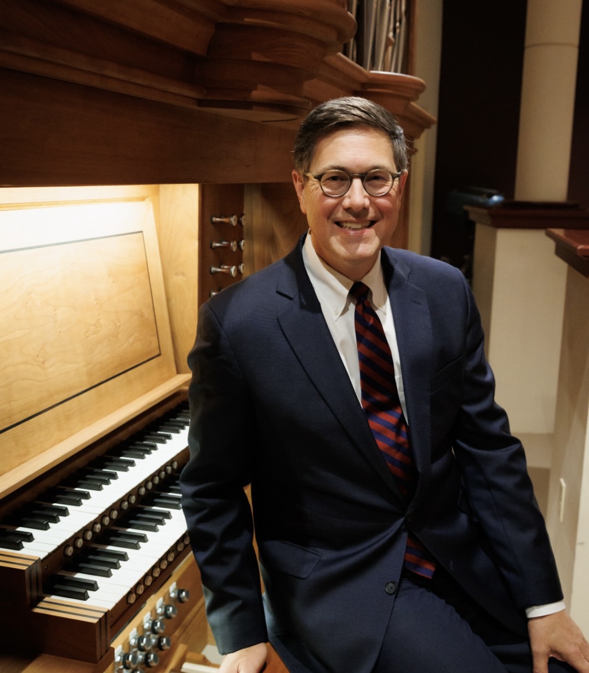 Jack Mitchener sits at organ.