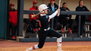 Mercer softball player swings bat during a game.