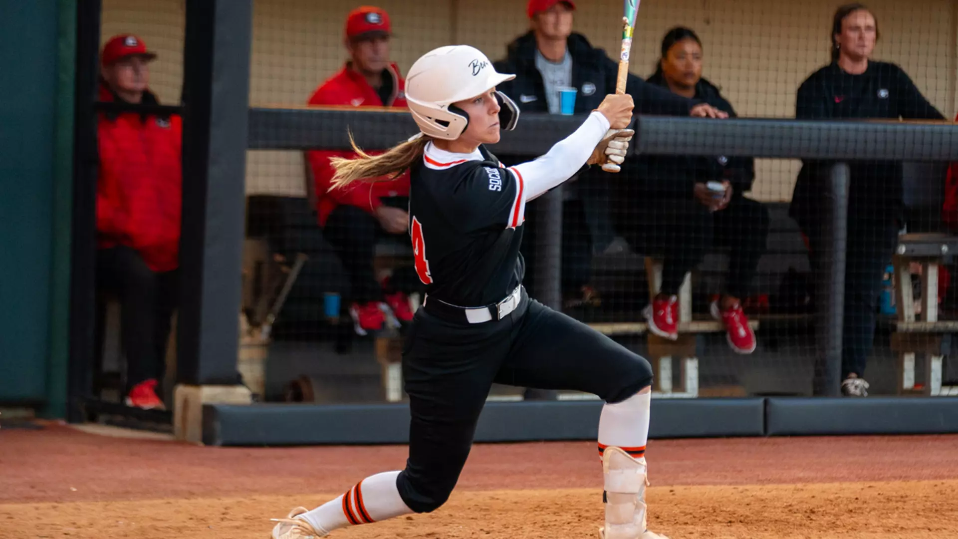 Mercer softball player swings bat during a game.