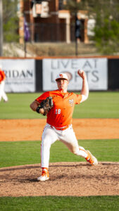 A Mercer baseball pitcher prepares to throw a pitch on a baseball field during a game.