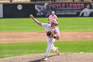A Mercer baseball pitcher throws a pitch during a game.
