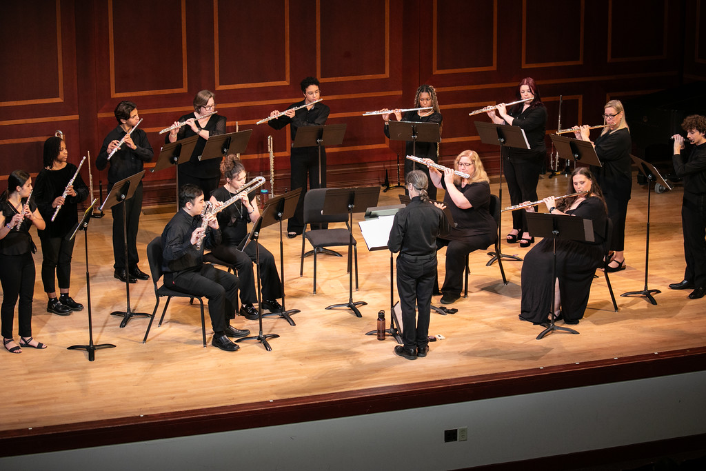 Mercer flute choir performs on stage.