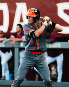 Mercer baseball player holding a bat, preparing to swing at home plate.