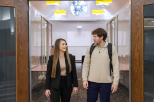 Two students walk side by side in the Mercer Innovation Center.