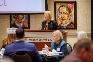 Mercer President Penny L. Elkins speaks behind a podium in the Presidents Dining Room.
