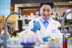 A pharmacy student works in a lab.