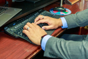 Hands typing on a keyboard.