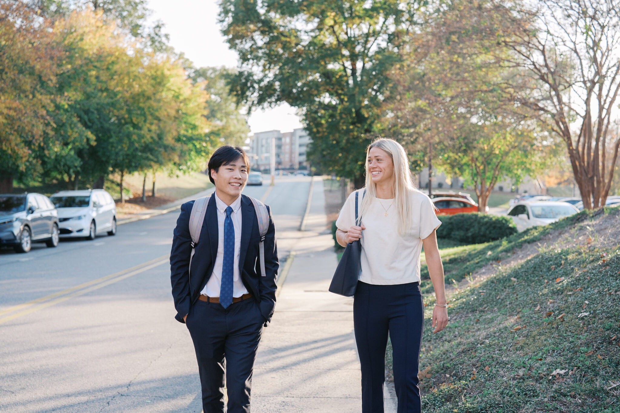 Two students in business attire walk on Mercer's campus.