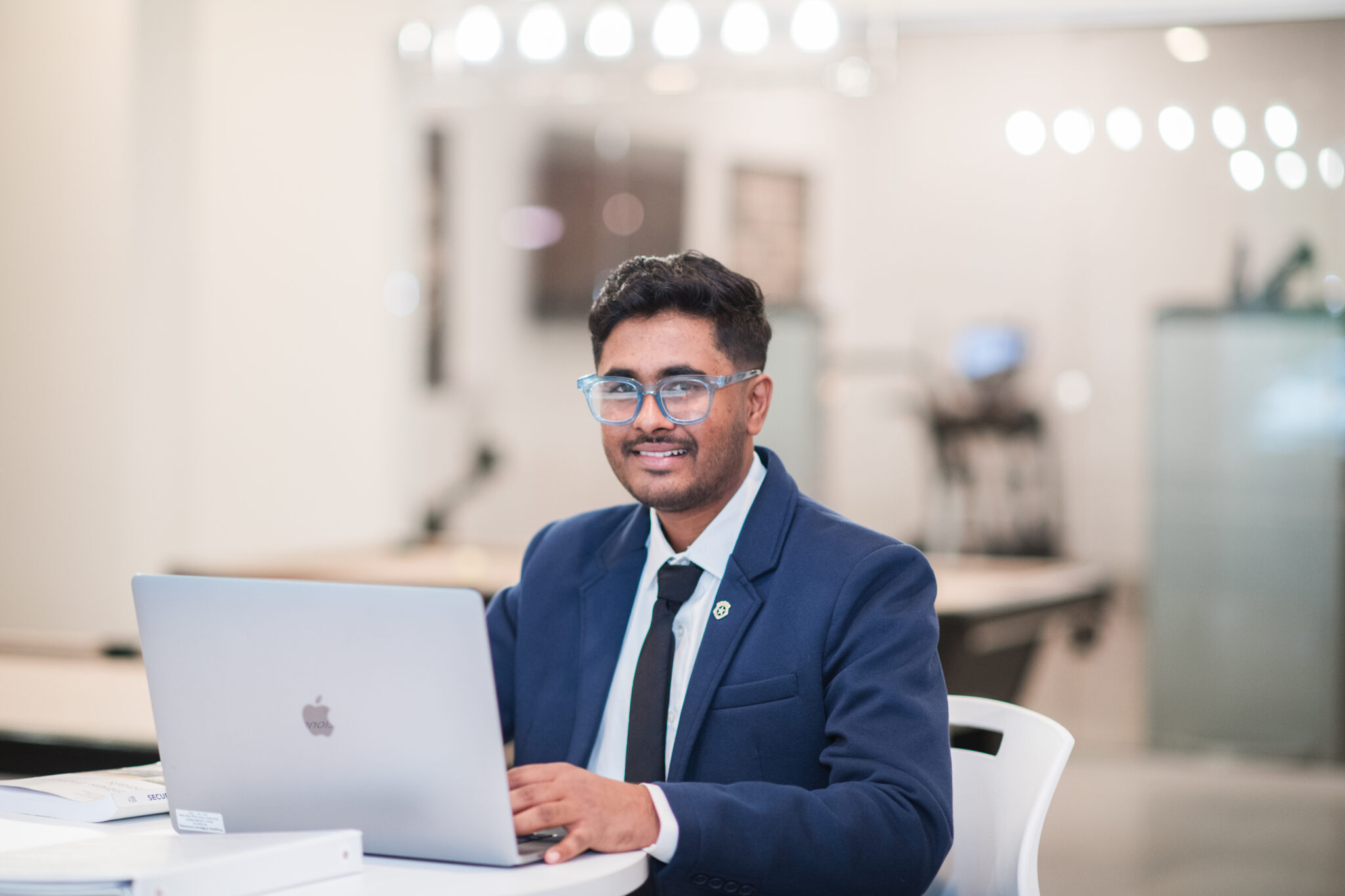 A Mercer MBA student sits at a computer.