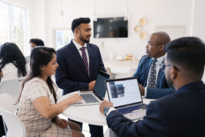 Mercer business students converse around a table.
