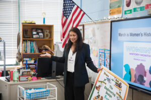 A teacher in a grade school classroom.