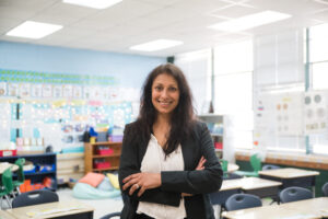 Teacher in grade school classroom.