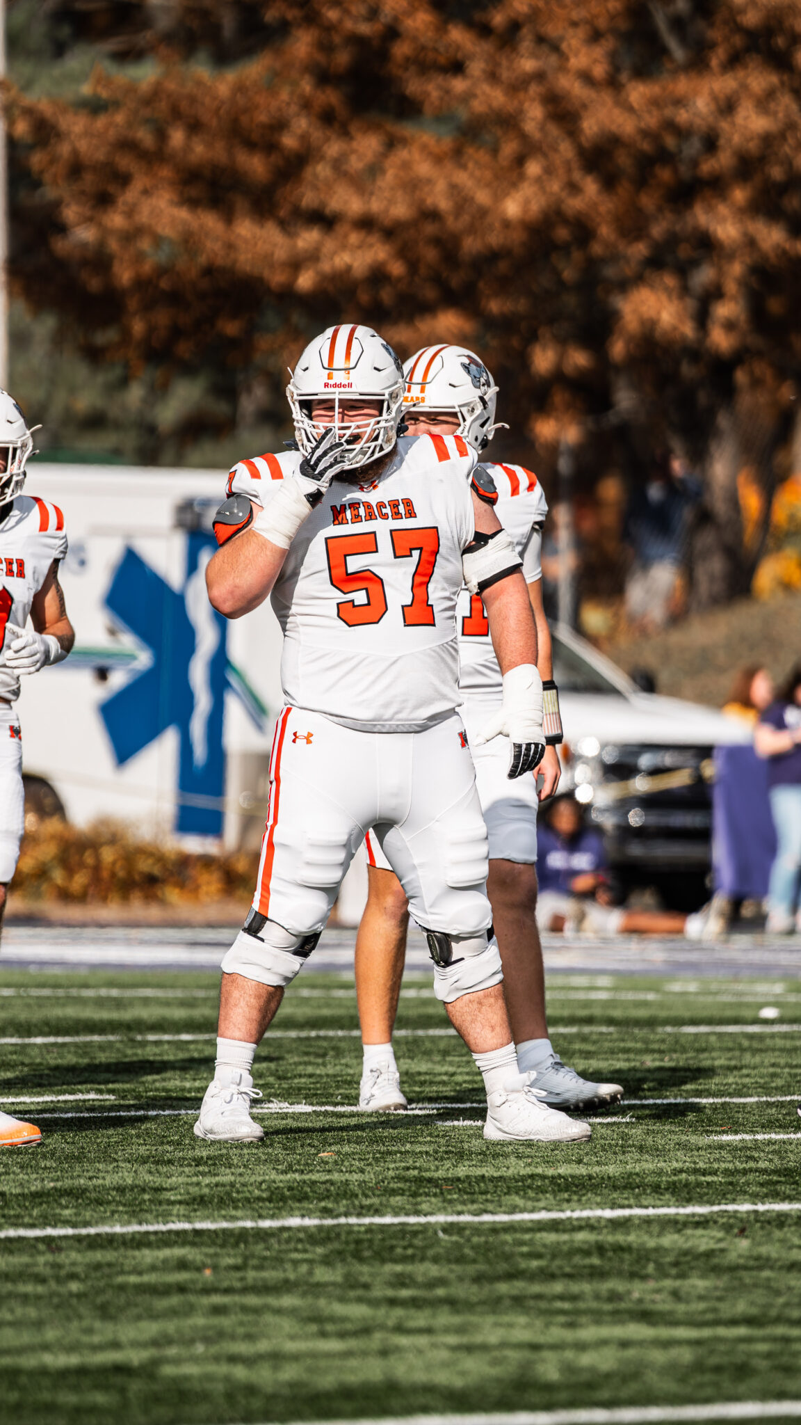 Mercer football player stands on field during a game.