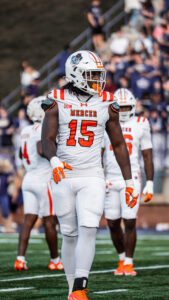 A Mercer University football player stands on the field during a game.
