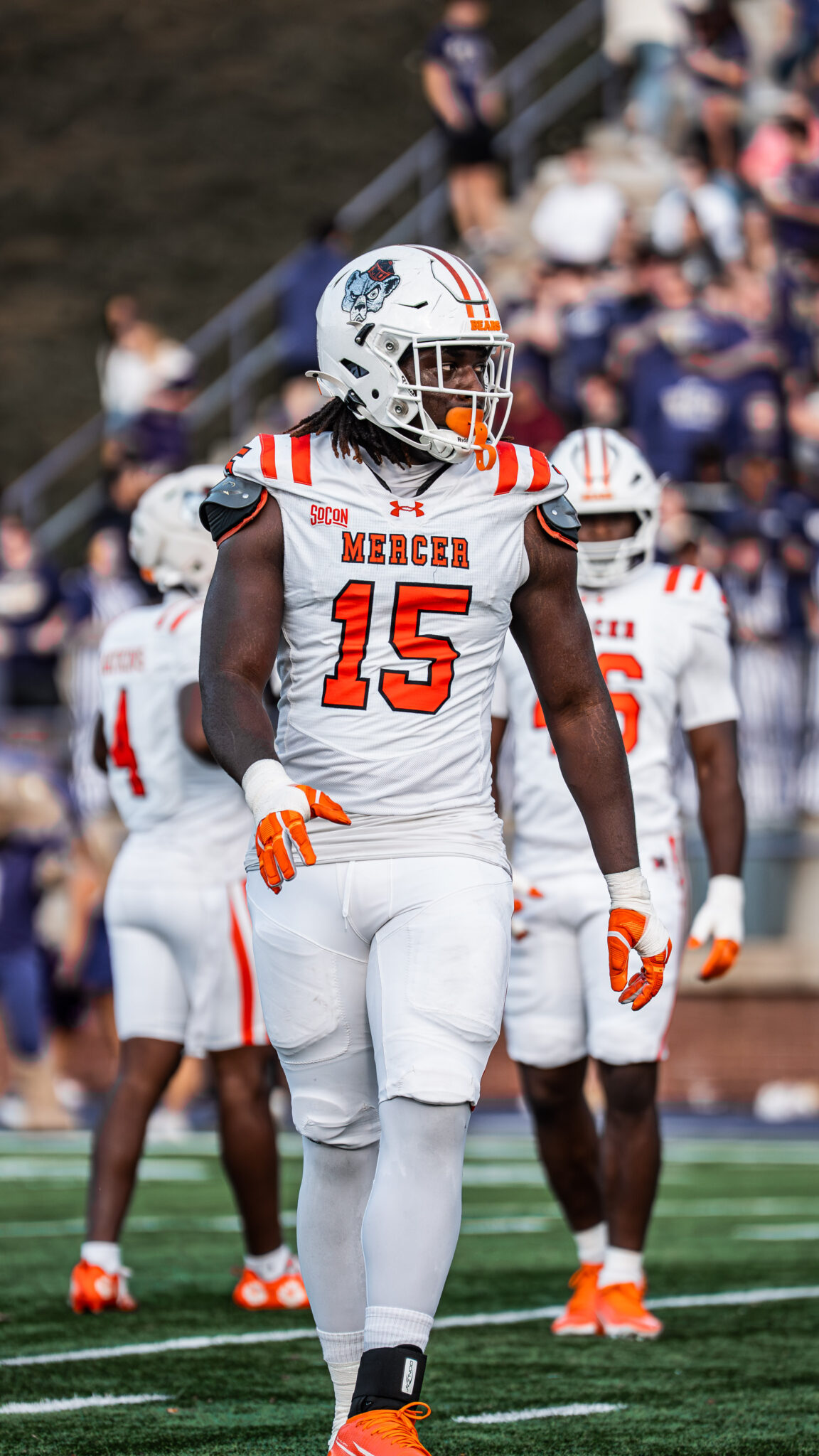 A Mercer University football player stands on the field during a game.
