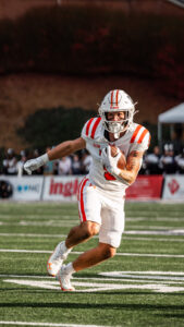 Mercer football player running with the ball during a game.