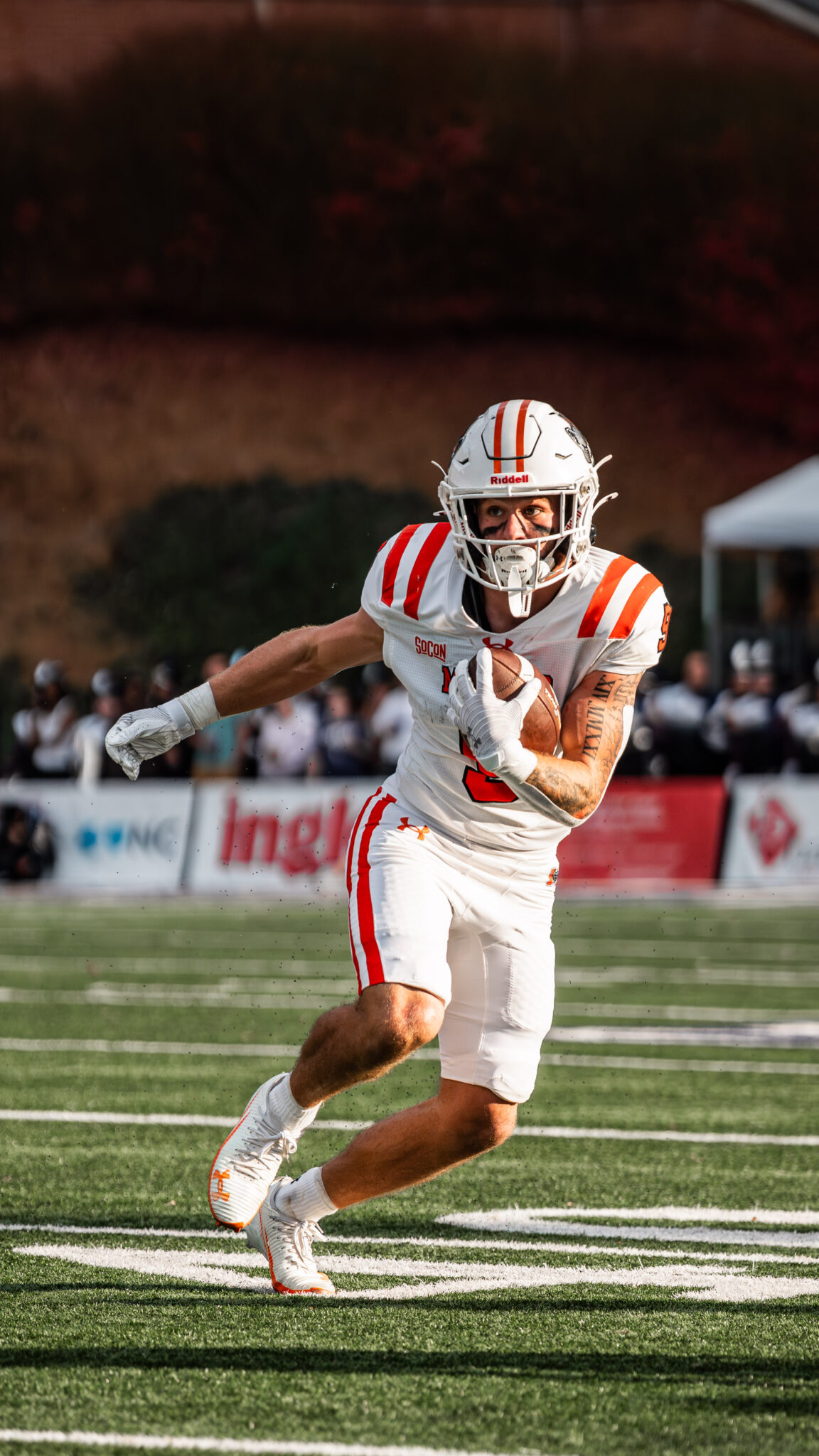 Mercer football player running with the ball during a game.