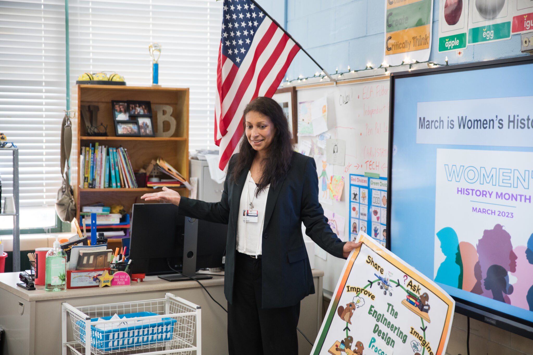 A teacher in a grade school classroom.