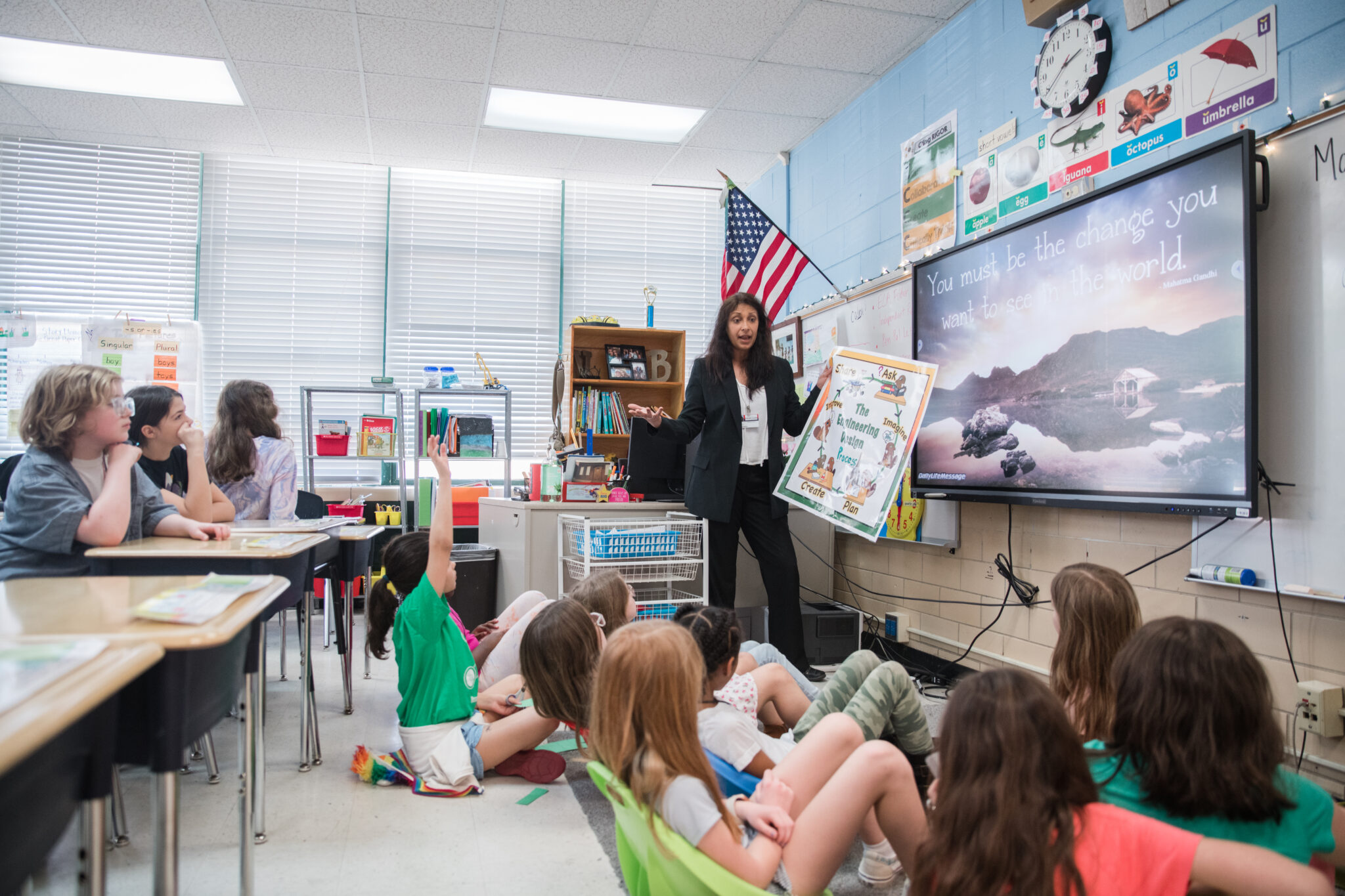 A teacher in a grade school classroom.